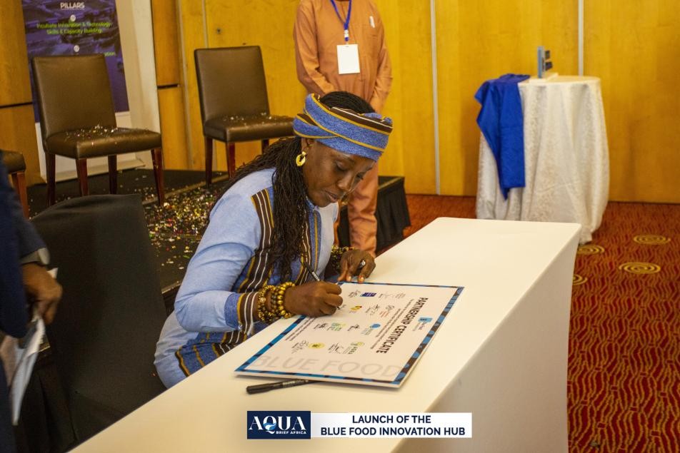 Ms. Akosa signing the partnership certificate for the Hub launch
